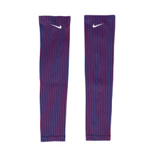 A pair of Nike Team USA women's armsleeves in red and blue striped pattern with the Nike logo on the upper part.