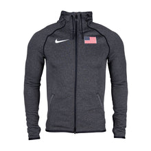 A grey Nike Team USA men's hoody with a hood, featuring raglan sleeves and a 2-way zip closure. It has a drawstring hood and two side pockets, with a printed branding on the chest.