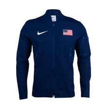 Nike Team USA Men's Podium Jacket in blue with a white and red design, featuring a prominent Nike logo on the chest and a smaller American flag on the sleeve.
