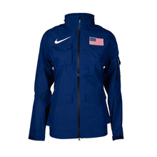 A navy blue Nike Team USA women's rain jacket with a foldable hood, featuring the American flag and Nike logo on the chest.