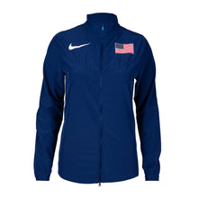 Nike Team USA women's woven jacket in blue with a visible American flag on the sleeve, featuring a front zipper and hand pockets.