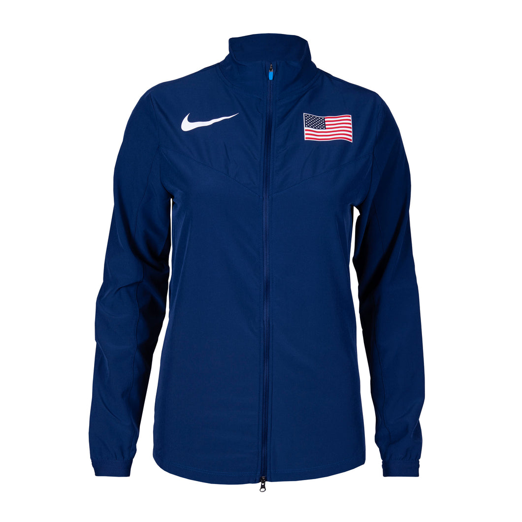 Nike Team USA women's woven jacket in blue with a visible American flag on the sleeve, featuring a front zipper and hand pockets.