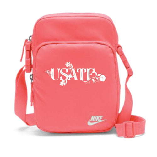Pink crossbody bag with 'USATF' and Nike logo on a white background